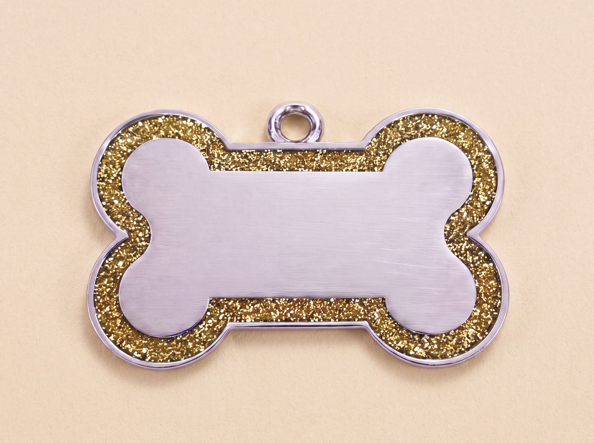 Botvormige hondenpenning met glitterrand en blanco midden, goud