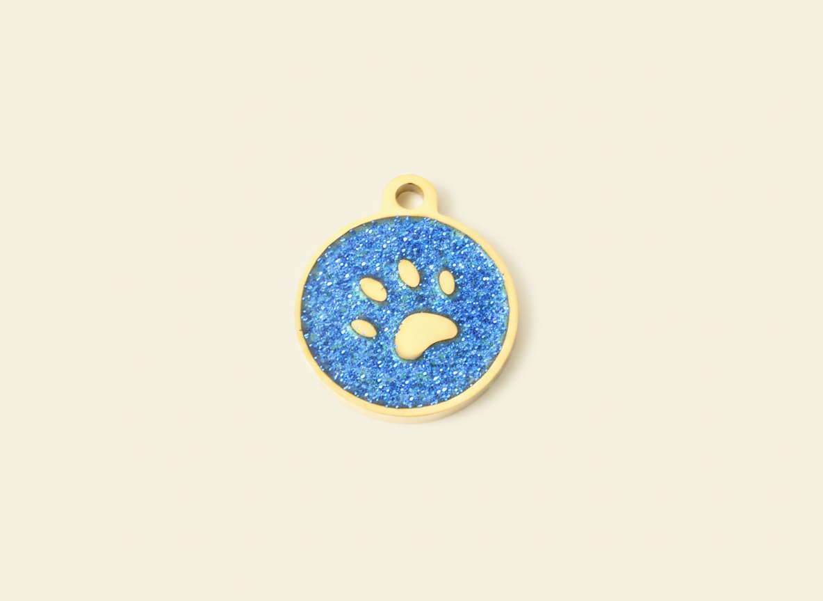Kleine huisdierpenning met goudkleurig pootafdrukje en glitterrand, blauw